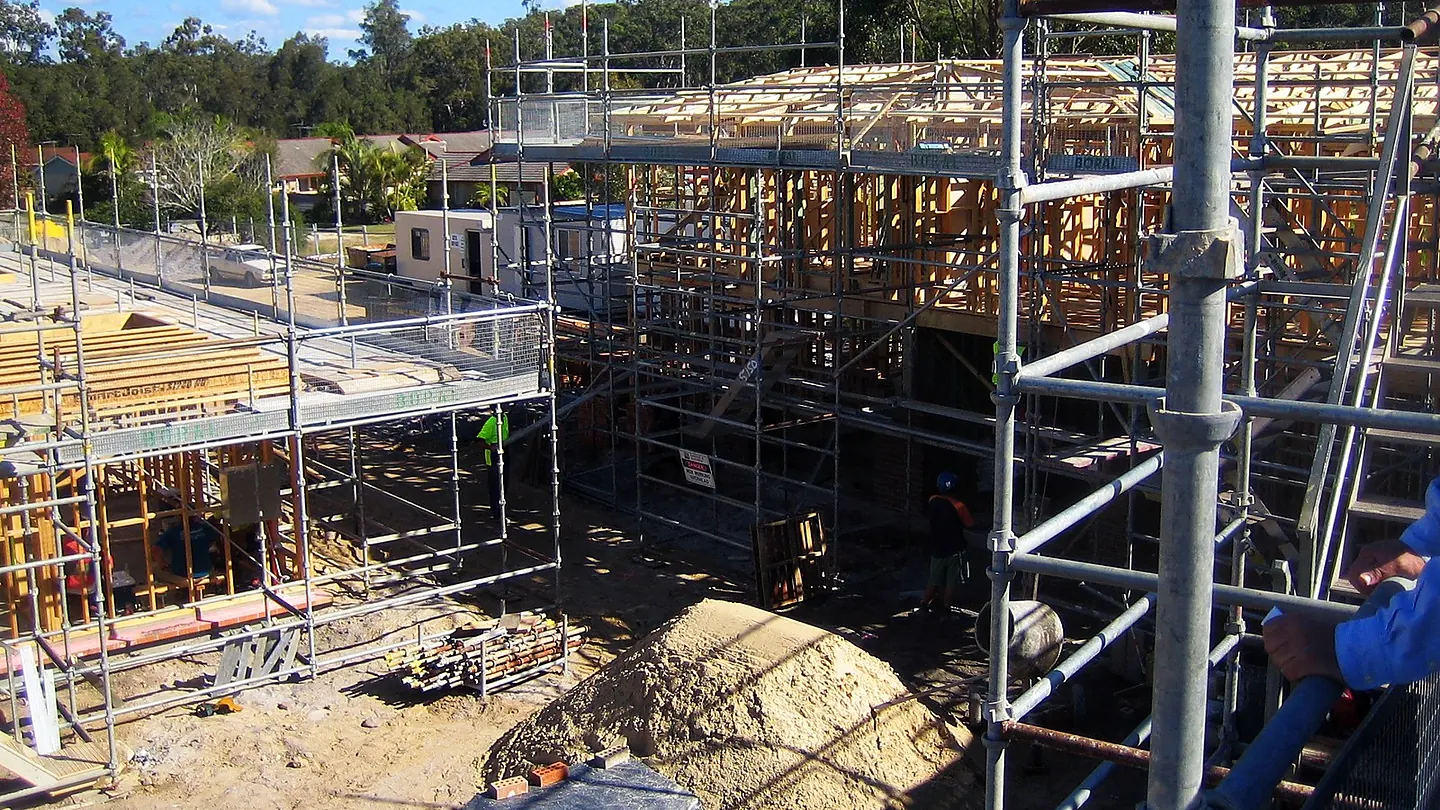 Timber framing and scaffold over a partly built structure, with bracing and formwork in place.